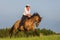 Mature woman riding an Andalusian horse