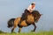 Mature woman riding an Andalusian horse