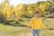 Mature woman with saplings in park on sunny day, space for text. Planting tree