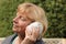 Mature woman with seashell