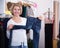 Mature woman selecting jeans in the shop