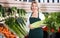 Mature woman selling vegetables.