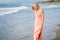 Mature woman on shore of a beach. Elderly female enjoying her retirement at a seaside retreat.