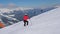 Mature woman skier skiing down the slope in the mountains at winter and brakes