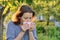 Mature woman sneezing in handkerchief, allergy to pollen, colds