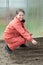 Mature woman sows seeds