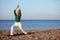 Mature woman stretching on the beach