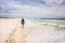 Mature Woman Strolling on Sunny Beach Artistic Photograph