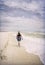 Mature Woman Strolling on Sunny Beach Artistic Photograph