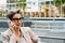 Mature woman talking on cellphone while standing on city street