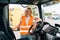 Mature woman truck driver steering wheel inside lorry cabin. Happy middle age female trucker portrait