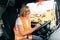 Mature woman truck driver steering wheel inside lorry cabin. Happy middle age female trucker portrait