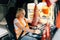 Mature woman truck driver steering wheel inside lorry cabin. Happy middle age female trucker portrait