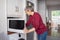 Mature woman using microwave oven