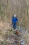 Mature woman walking along a path with her dachshund with her mobile phone gimbal in hand