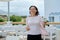 Mature woman walking with cup of coffee in outdoor restaurant resort hotel