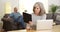 Mature woman working on tablet laptop computer at desk