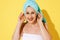 Mature woman wrapped in shower towels smiling and looking at camera