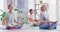 Mature women meditating in lotus pose with mudra hand gesture during a fitness class in a yoga studio. Calm, relaxed and