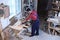 Mature working man using circular saw at carpentry shop