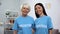 Mature and young women in volunteer t-shirts smiling on camera, assistance