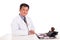 Matured Asian medical practitioner seated behind desk