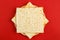 Matzah in the form of a star of David on a red background
