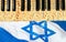 Matzoh (matzah, matzo) piano keys over Israeli national flag. Jewish music concept