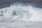 MAUI, HI - MARCH 10, 2015: Professional surfer rides a giant wave at the legendary big wave surf break \