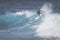 MAUI, HI - MARCH 10, 2015: Professional surfer rides a giant wave at the legendary big wave surf break \
