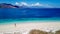 Maumere - A drone shot of a girl playing on the white sand beach