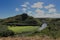 The Maunakapu mountains and Wailua River in Kauai with a group of kayakers in the distance