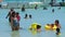 Mauritius, Blue Bay Beach, 18 January 2022: Indian happy family swimming in warm ocean with blue water. People of Indian