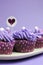 Mauve purple decorated cupcakes - closeup vertical with copy space.