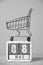 May 08, shopping cart and wooden calendar gray background.Concept for Fair Trade Day.