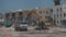 May 11, 2021 Cyprus, Paphos. Construction work with construction equipment and road renovation workers in city near