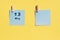 May 13st . Day of 13 month, calendar date. Two blue sheets for writing on a yellow background. Top view, copy space. Spring month