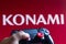 May 17, 2021, Brazil. In this photo illustration the controller for PlayStation PS and in the background the company logo Konami