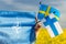 May 19, 2022, Fashion A woman holds the flags of NATO, Finland and Sweden, Concept of social support of both countries to join the