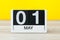 May 1st. Day 1 of month, countdown calendar close-up, at yellow background. Spring time