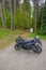 May 2021 Parma, Italy: Kawasaki motorcycle parked close-up across path in the woods.