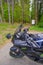 May 2021 Parma, Italy: Kawasaki motorcycle parked close-up across path in the woods. Adventure