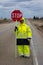 MAY 21, 2019 - ROUTE 2, MONTANA - Highway worker with stop sign on Route 2, Montana outside Fort Benton