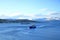 May 28 2022 - Tromso, Norway: Ships approach the port, Snowy mountains in the background