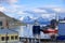 May 28 2022 - Tromso, Norway: Ships approach the port, Snowy mountains in the background