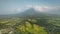 Mayon volcano erupts at Philippines countryside aerial. Tropic green forest plants and grasses