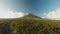 Mayon Volcano near Legazpi city in Philippines. Aerial view over the palm jungle and plantation at sunset. Mayon Volcano