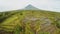 Mayon Volcano near Legazpi city in Philippines. Aerial view over rice fields. Mayon Volcano is an active volcano and