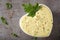 Mayonnaise sauce with chopped onion and mustard seeds in a white bowl with herbs