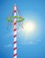 maypole with colorful ribbons on blue sunny sky background